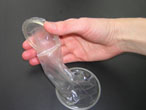 Hand holding an internal/female condom